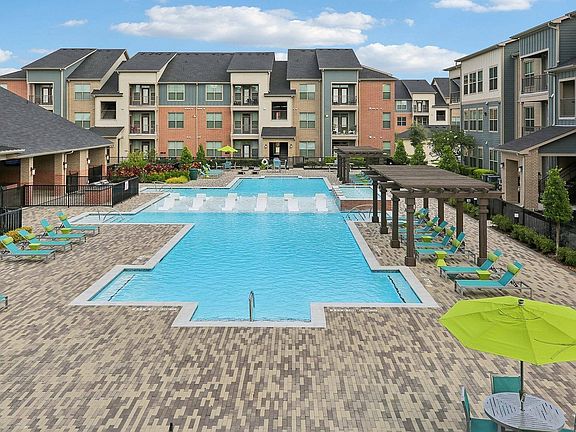 Enjoy sunny days by the shimmering pool at Cityscape Apartments in Houston, Texas.