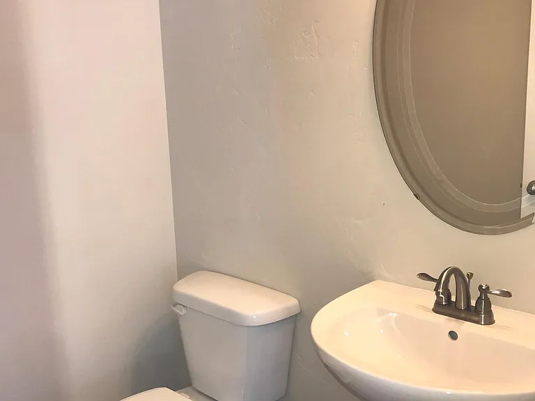 Half Bath/Adjacent to Entryway and Den/Office with Coat Closet across the Hallway