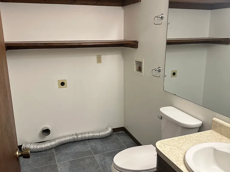 Powder room with washer and dryer hookups on main level.