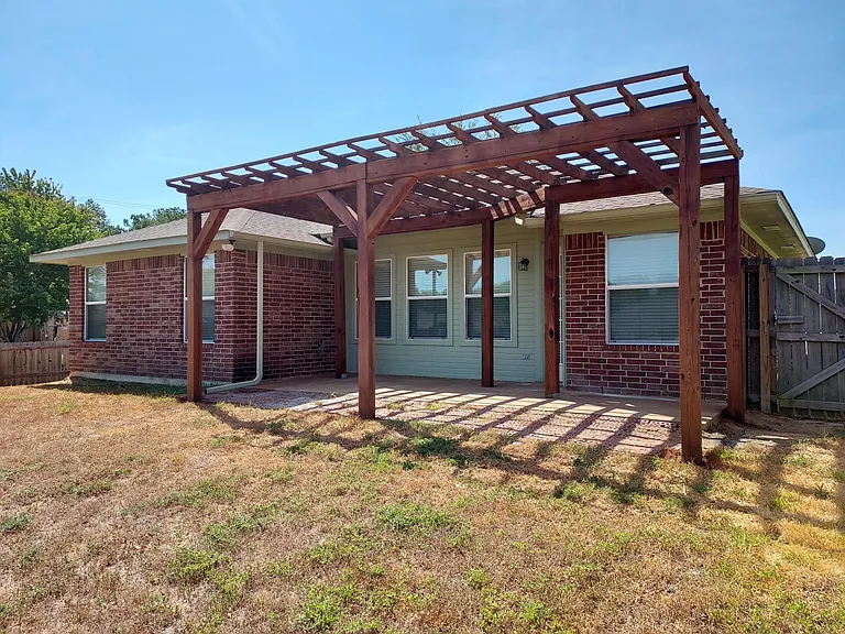 Back of house with pergola