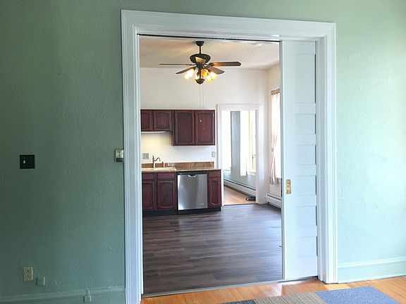 Looking through kitchen from living room towards bedroom door