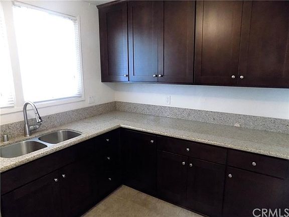 The kitchen window looks out onto the yard. Lots of storage here.