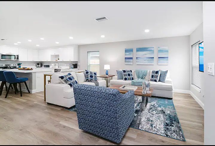 An open living area with cozy seating, stylish decor, and a large smart TV, perfect for relaxation after a day of local adventures.