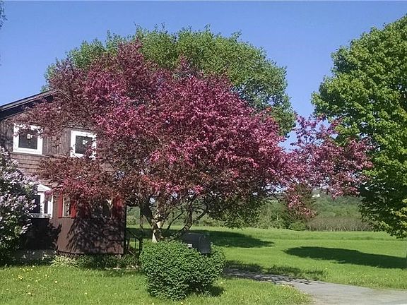 Beautiful flowering trees and lilacs add to the perfect setting.