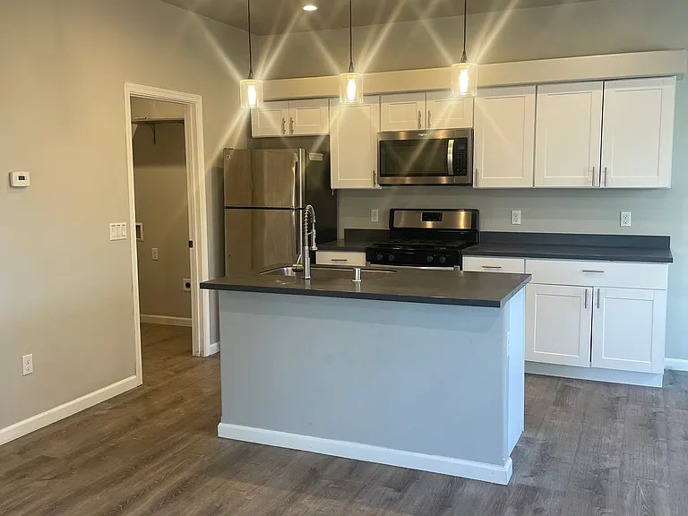 White kitchen cabinets, Corian counter tops. Stainless steel appliances.