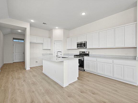 Kitchen in the Cedar home plan by Trophy Signature Homes - REPRESENTATIVE PHOTO