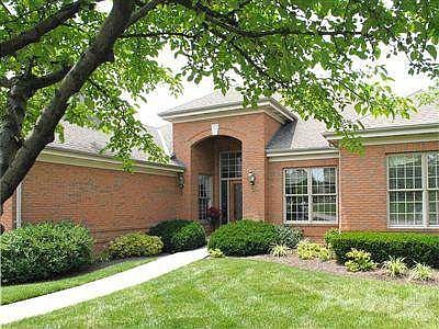 Walkway to stately entrance, impressive glass door and sidelights.