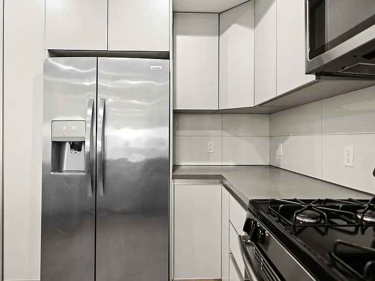 Kitchen with Stainless-Steel Refrigerator, Stove, and Microwave Oven