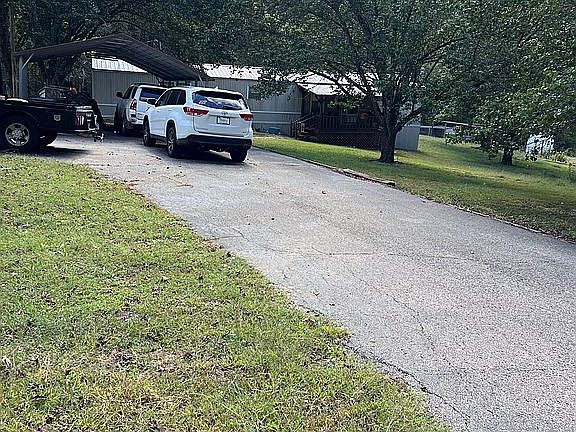 Paved driveway with carport