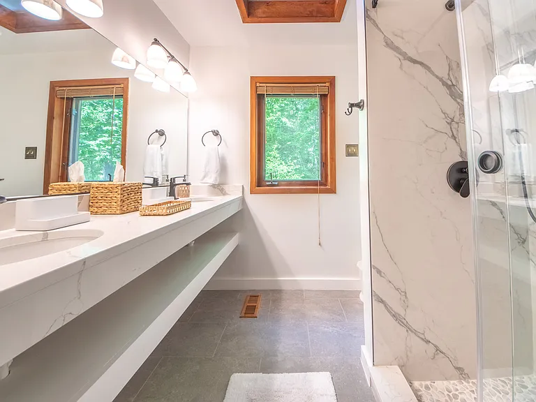 Guest bath with double sinks and Brazilian Porcelanato shower.