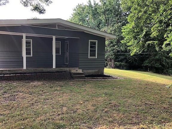 Car port and spacious backyard
