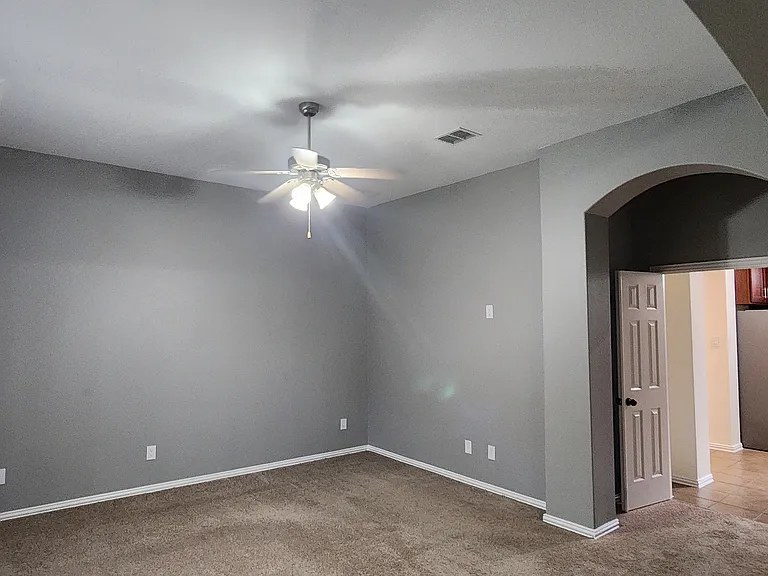Primary bedroom with double doors and sitting area.