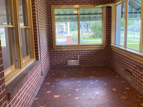 Enclosed front porch with air conditioning. Original tile.