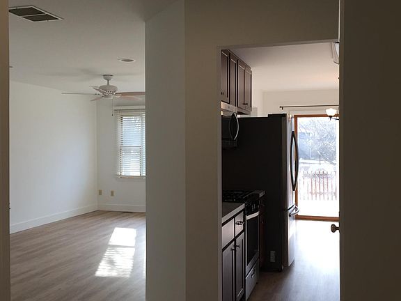 Main floor hall, living room on left, kitchen on right.