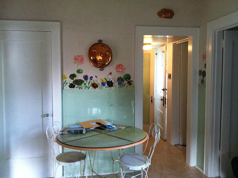 Kitchen with tile and decorative painting
looking toward back door hallway