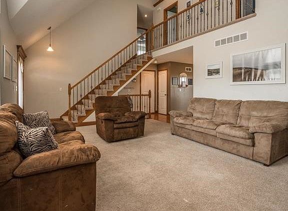 This wide open great room entry provides a wide stairway to upper level and entry to the dining room.