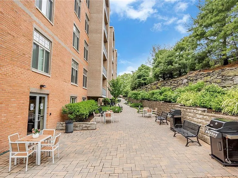 Outside Patio with BBQ Grills & Lush Landscaping - Common Area