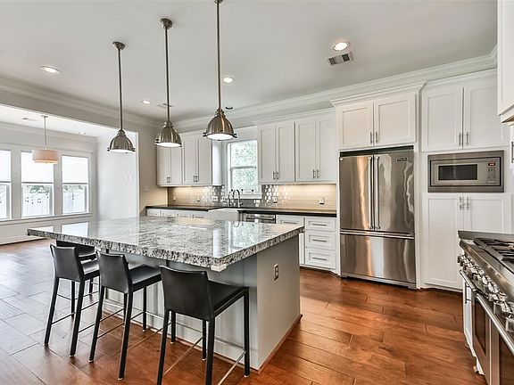 This gourmet kitchen is every cook's dream providing stainless steel appliances, professional 6 burner gas range, farmhouse sink, breakfast room and serving bar.