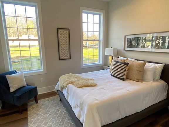 Spacious secondary bedroom includes tall windows and recess lights for ample lighting