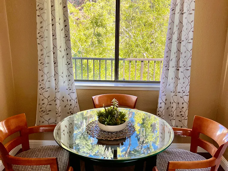 Sunny kitchen nook with contemporary seating for 4. Beautiful view of Monterey pines.