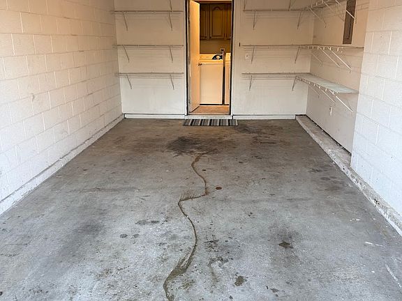 ATTACHED Garage with Shelving and Open Access to Laundry/Mudroom