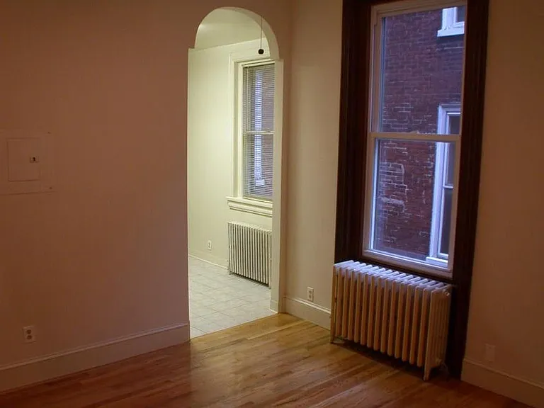 living room, doorway to kitchen, windows in living room