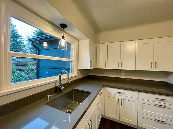 Brand new cabinets and countertops. Window looks out to the backyard.