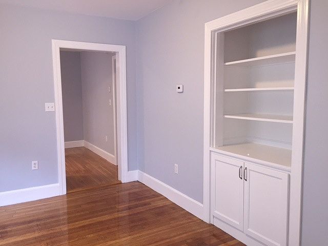 Dining room with built-in shelves and cabinets