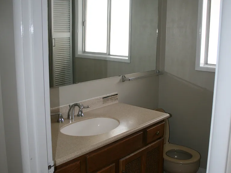 The back full bathroom is across from the master bedroom. A raised counter top, and an extra built in storage cabinet next too the tub gives room for towels and toiletries.
