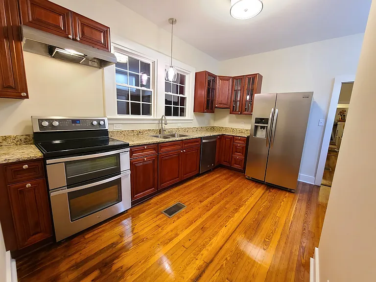 Kitchen w/ new cabinets, granite counters, electric ss stove/oven, ss overhead stove light/vent, ss dishwasher, ss double sink, garbage diposal, and ss french door refrigerator.