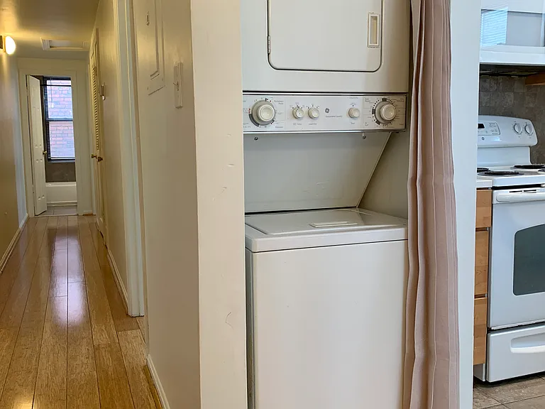 Hallway leads to two bedrooms and bathroom at end of hallway. Beautiful bamboo flooring throughout. Kitchen and Bathroom are porcelain tile.