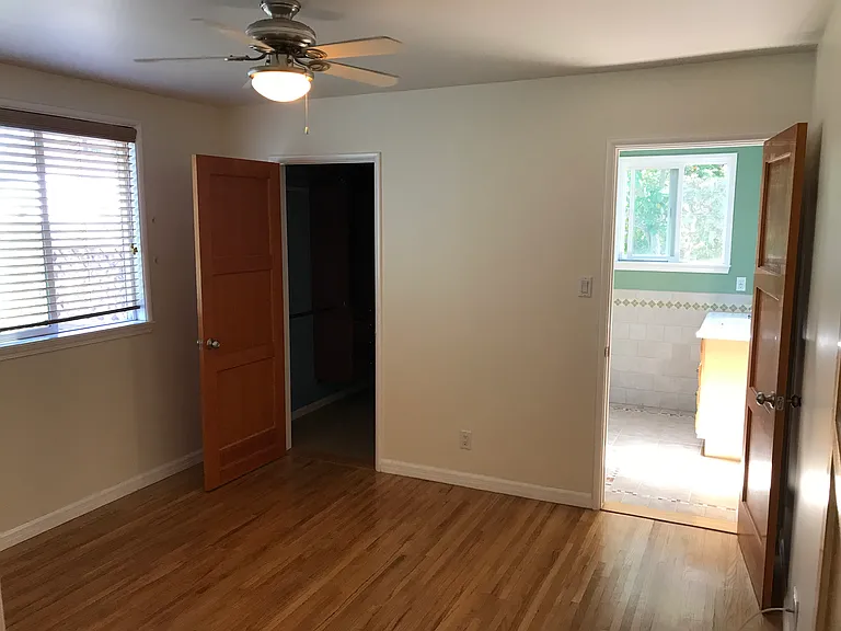 Master bedroom with original oak flooring, walk-in closet and private bathroom.
