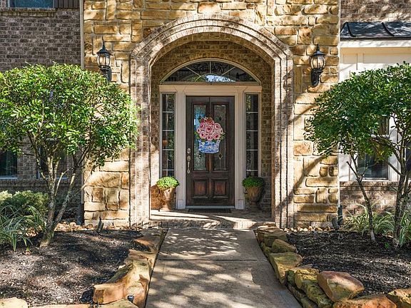 Covered front porch with gorgeous wood and lead glass front door welcomes you into your new home.