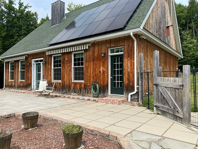 Photo of the front of the home taken from staircase. Solar panels on front, right side.