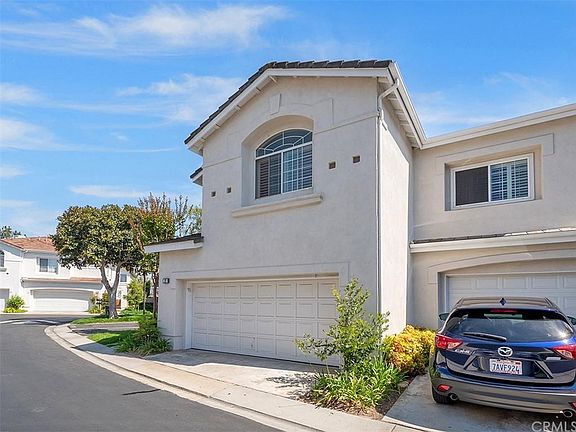 Front of House with View of Garage and Neighbor