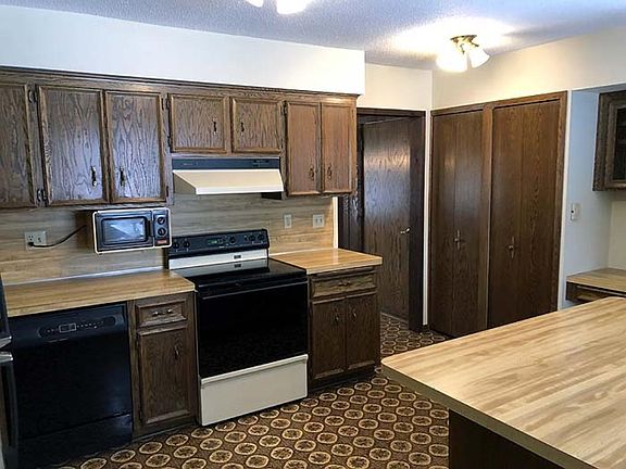 Spacious kitchen with oak cabinets.