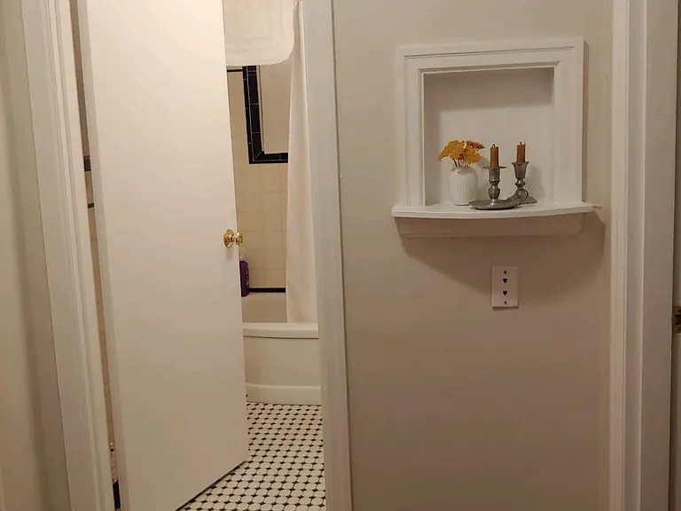 Love this quirky little area! The inset to the right of the bathroom was originally where a rotary telephone once lived. We loved it and kept.