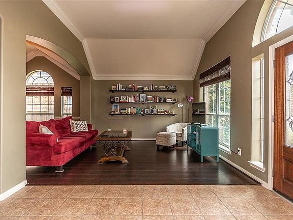 The Formal Living Area is light and bright.  Notice the engineered wood floors and the double crown molding.