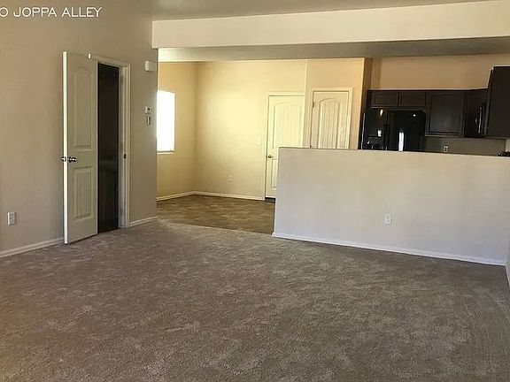 living room - with view to kitchen and dining area, with 1/2 bath to the left