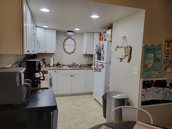 Bright kitchen with newer dishwasher, range, refrigerator and much counter space.