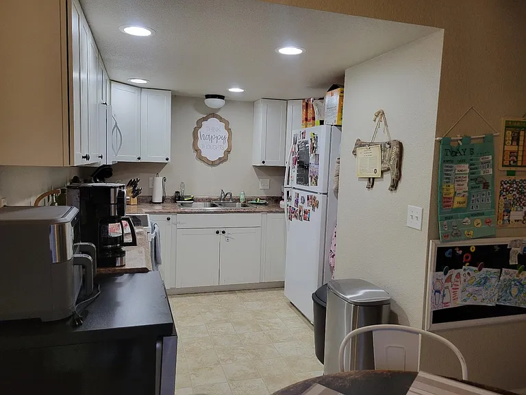 Bright kitchen with newer dishwasher, range, refrigerator and much counter space.