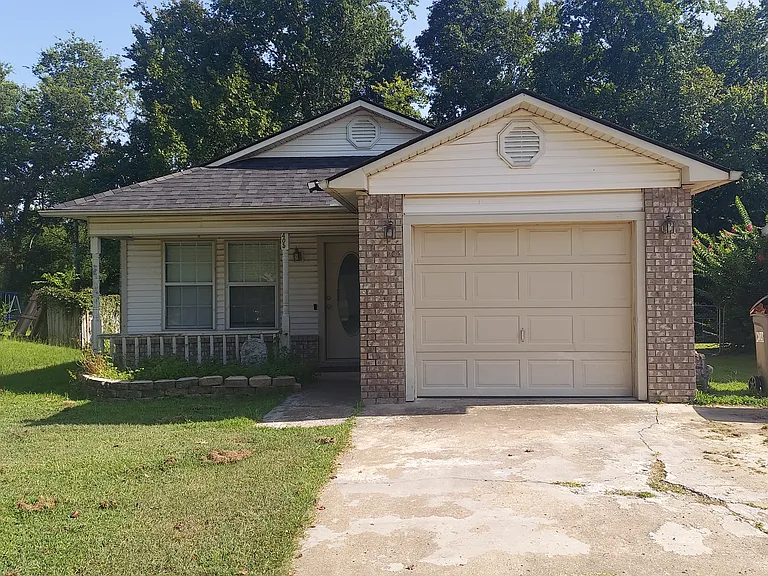 Front of house; 2 tress on front yard near street not pictured