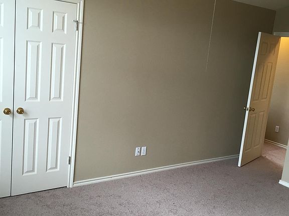 Master bedroom with large closet and ceiling fan