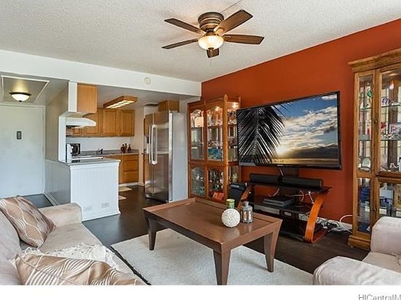 Looking into the kitchen and front hallway from the living room.