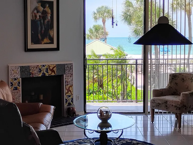 Living room has pool and beach view. 
Dining room table seats 6