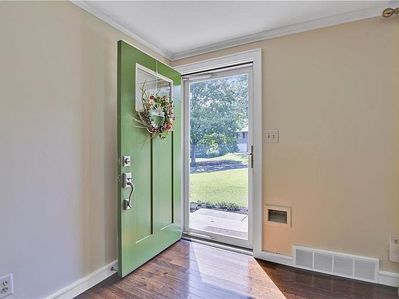 All exterior AND interior doors are new, fresh hardwoods and cute mail drop as you enter the living room.