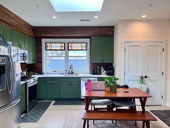 Kitchen with a skylight, and washer/dryer in the closet to the right.