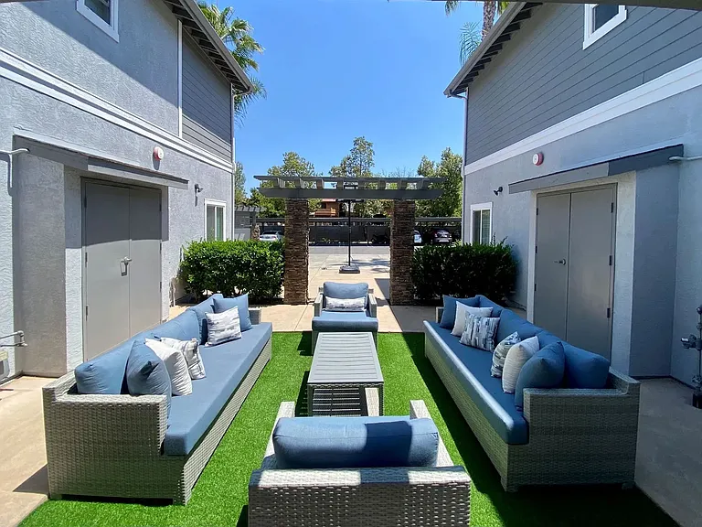Community patio with couches at the Nines Townhomes in Escondido, California.