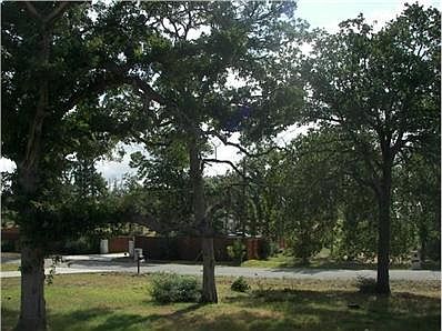 Beautiful tall shade trees in the front yard .