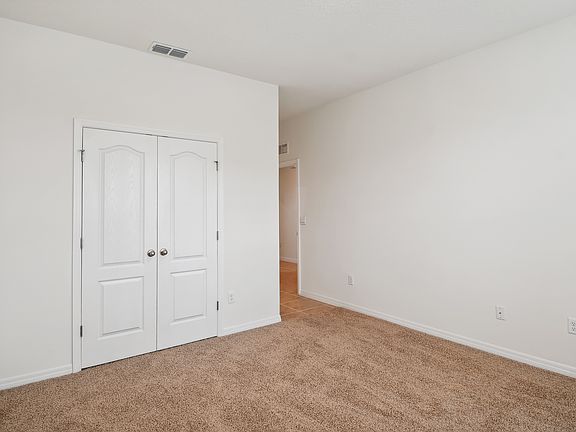 First bedroom downstairs with en suite bathroom at front of home.